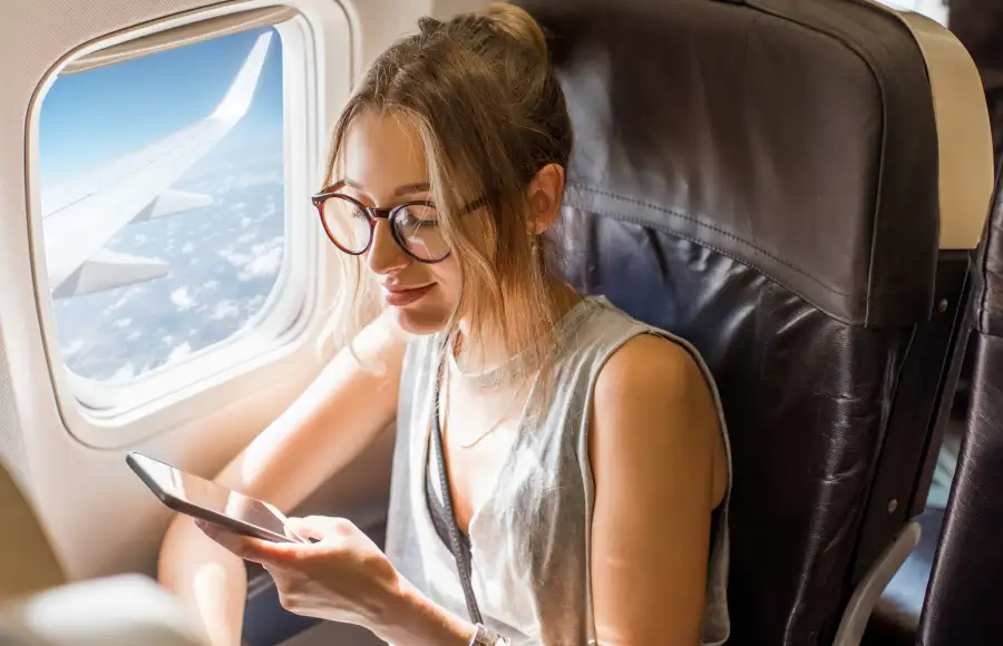 Woman using Wi-Fi on plane